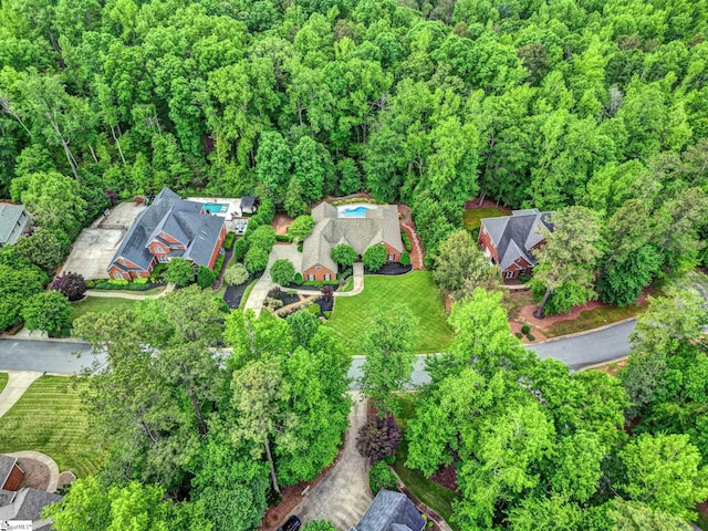 view of property location featuring a heavily wooded area