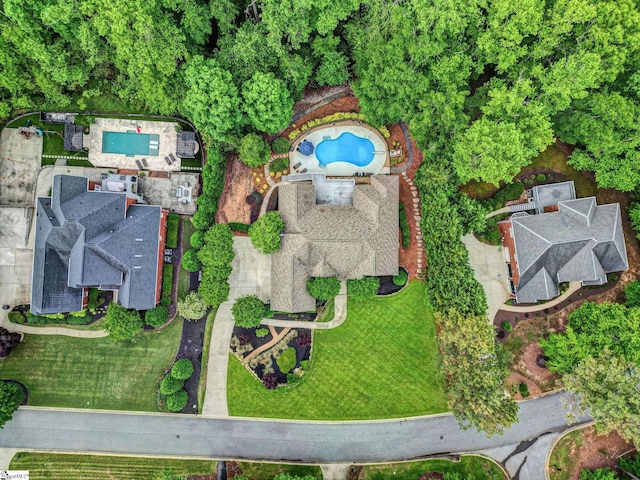 aerial view of property and surrounding area featuring a pool
