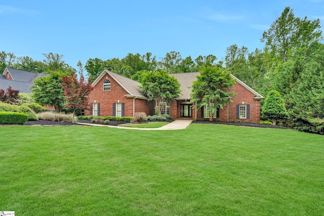 view of front of home with a front yard and brick siding