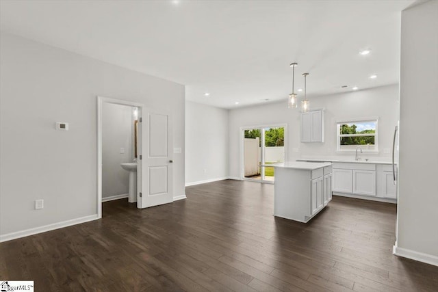 102 Randwick Ln, Greer, SC 29651 - kitchen featuring a center island, dark wood-type flooring, light countertops, baseboards, and hanging light fixtures