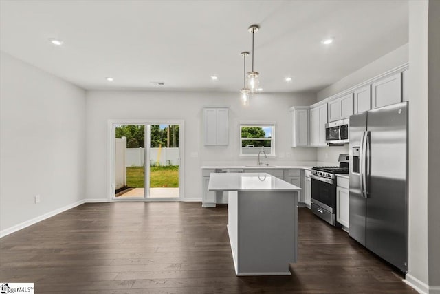 102 Randwick Ln, Greer, SC 29651 - kitchen featuring stainless steel appliances, a sink, a kitchen island, light countertops, and dark wood-style floors
