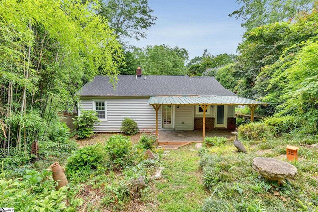 14 Dixie Ave, Greenville, SC 29607 - view of front of property featuring a patio area, a shingled roof, and a chimney