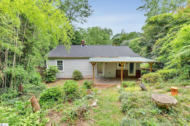 14 Dixie Ave, Greenville, SC 29607 - view of front of property featuring a patio area, a shingled roof, and a chimney