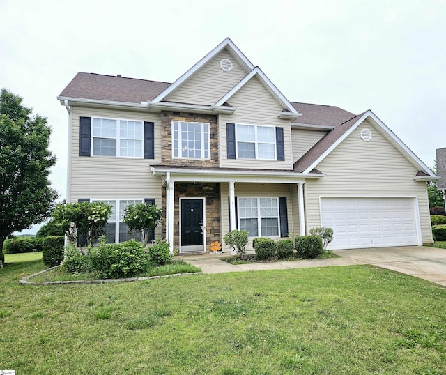 view of front of property with driveway, a front yard, stone siding, and a garage