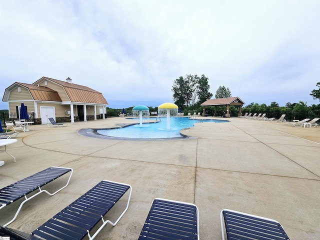 community pool featuring a gazebo, a patio, and fence