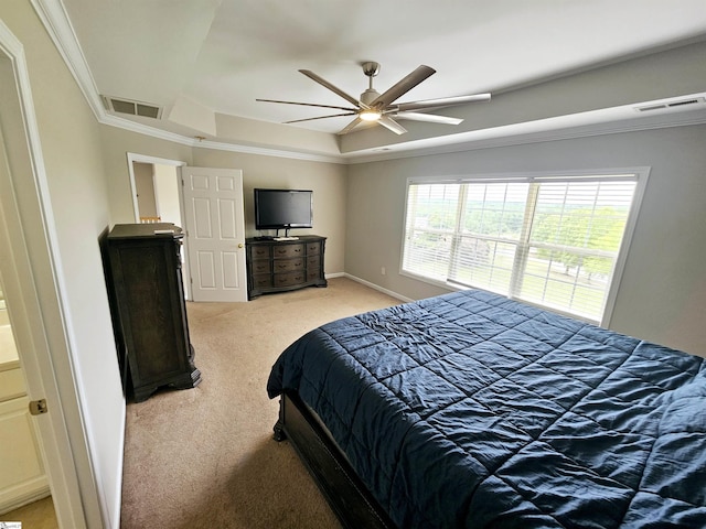 bedroom featuring light colored carpet, a raised ceiling, crown molding, ceiling fan, and baseboards