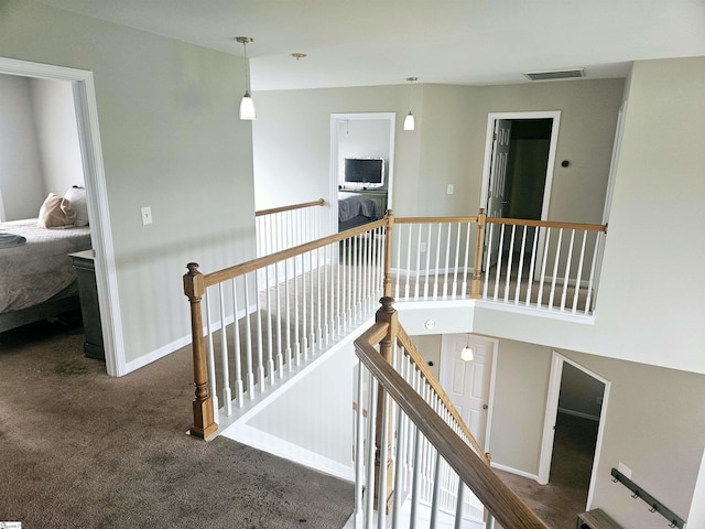 stairway featuring carpet flooring and baseboards