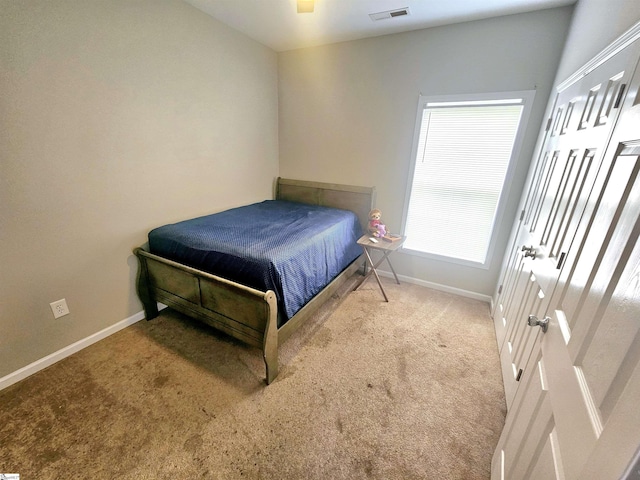bedroom featuring baseboards and carpet