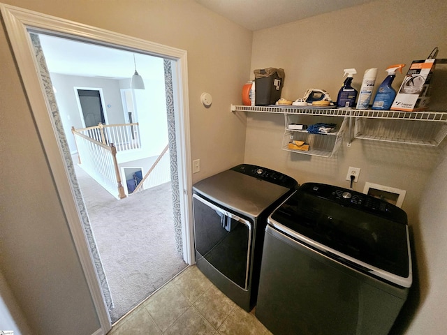 washroom featuring separate washer and dryer and light tile patterned floors