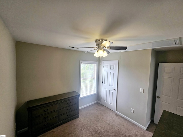 unfurnished bedroom featuring carpet floors, baseboards, a ceiling fan, and a closet