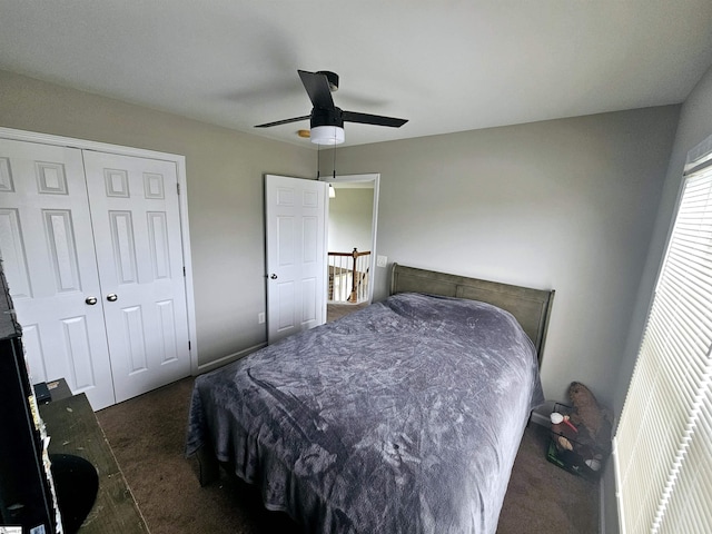 carpeted bedroom with ceiling fan and a closet