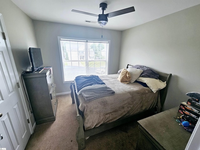 carpeted bedroom featuring a ceiling fan and baseboards