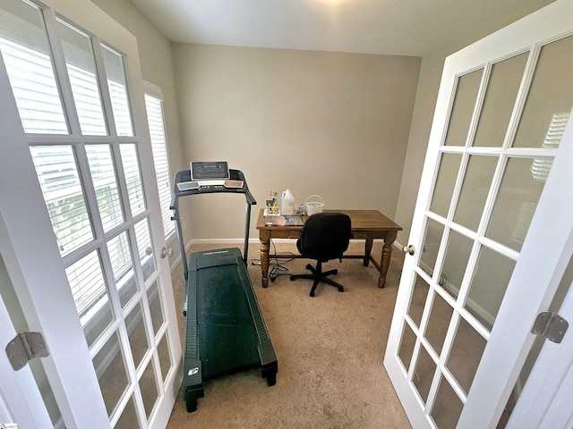 carpeted home office with french doors