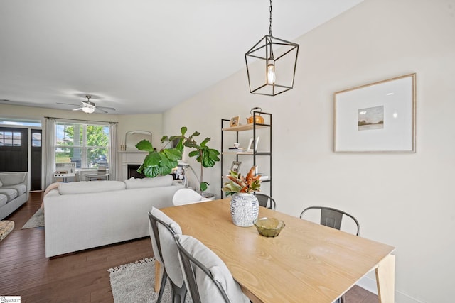 dining space with dark wood-type flooring and a ceiling fan