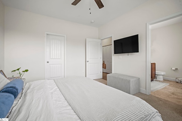 bedroom with baseboards, carpet flooring, ensuite bathroom, a closet, and ceiling fan