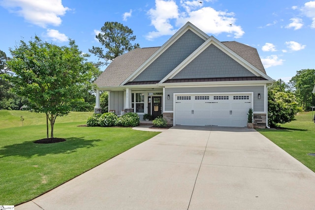 craftsman inspired home with a front yard, an attached garage, a standing seam roof, and driveway