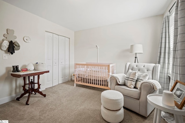 carpeted bedroom featuring a closet and baseboards