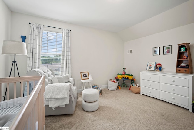 carpeted bedroom with a nursery area, baseboards, and vaulted ceiling