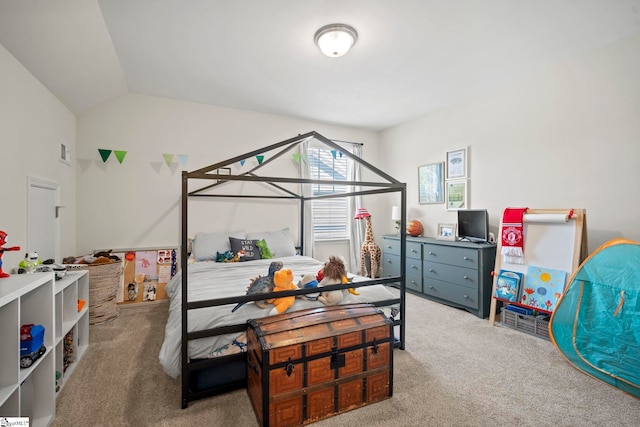 carpeted bedroom with lofted ceiling