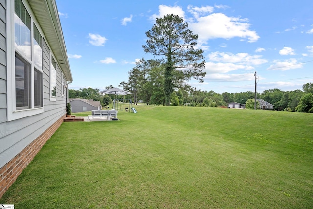 view of grassy yard with a playground