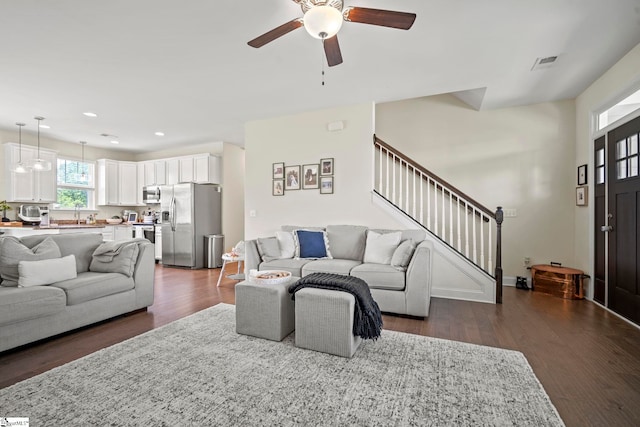 living room featuring a ceiling fan, stairs, dark wood-type flooring, recessed lighting, and baseboards