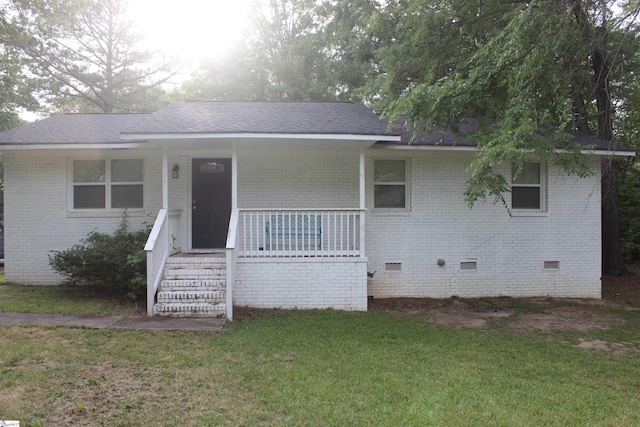 305 N Owens St, Clinton, SC 29325 - view of front of house with crawl space, brick siding, covered porch, and a front yard