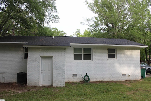 305 N Owens St, Clinton, SC 29325 - back of property featuring crawl space, cooling unit, brick siding, and a yard