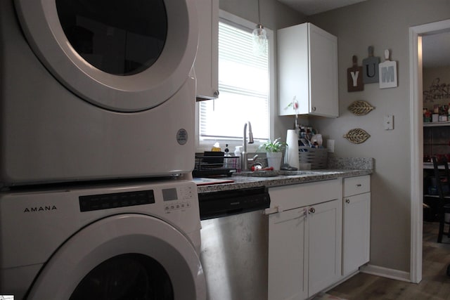 305 N Owens St, Clinton, SC 29325 - laundry room featuring estacked washer and dryer, plenty of natural light, and wood finished floors