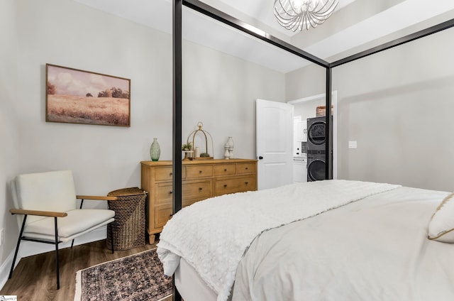 203 N Hogan Dr, Westminster, SC 29693 - bedroom featuring stacked washer / drying machine, wood finished floors, and baseboards