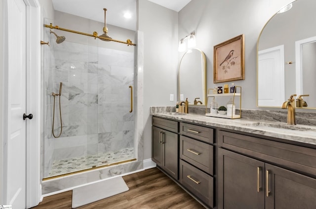 203 N Hogan Dr, Westminster, SC 29693 - full bathroom featuring a stall shower, double vanity, wood finished floors, and baseboards