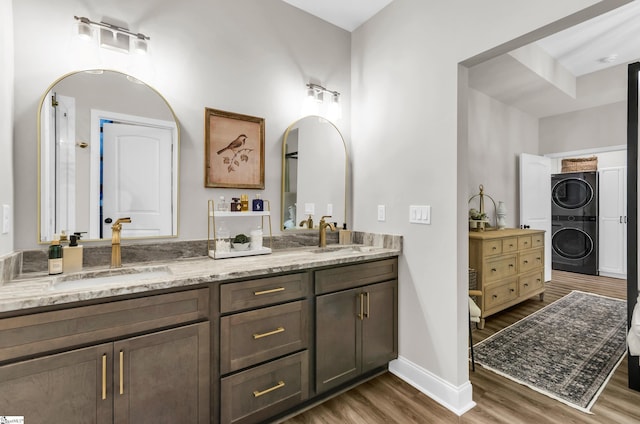 203 N Hogan Dr, Westminster, SC 29693 - full bathroom with estacked washer and dryer, wood finished floors, baseboards, and double vanity