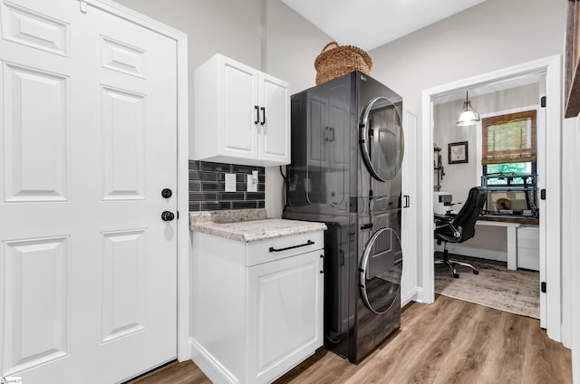 203 N Hogan Dr, Westminster, SC 29693 - laundry area featuring estacked washer and dryer, light wood-style flooring, cabinet space, and a desk