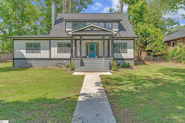 view of front of property featuring covered porch, a chimney, board and batten siding, and a shingled roof