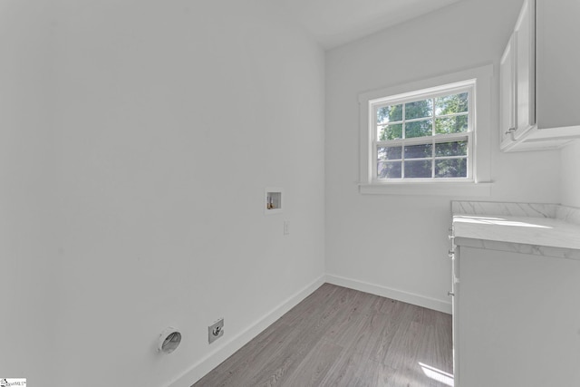 laundry room featuring hookup for a washing machine, light wood-style flooring, baseboards, hookup for an electric dryer, and cabinet space