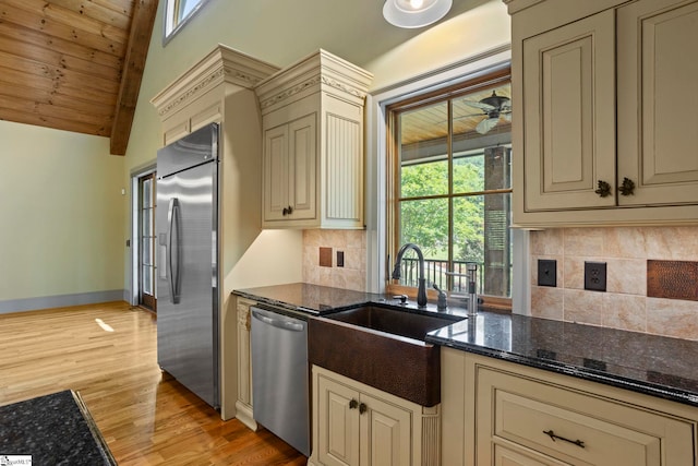 160 Mountain Brook Trl, Greenville, SC 29609 - kitchen featuring cream cabinets, appliances with stainless steel finishes, a sink, light wood finished floors, and dark stone countertops