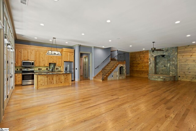 160 Mountain Brook Trl, Greenville, SC 29609 - unfurnished living room featuring a stone fireplace, a ceiling fan, light wood-style floors, recessed lighting, and stairway