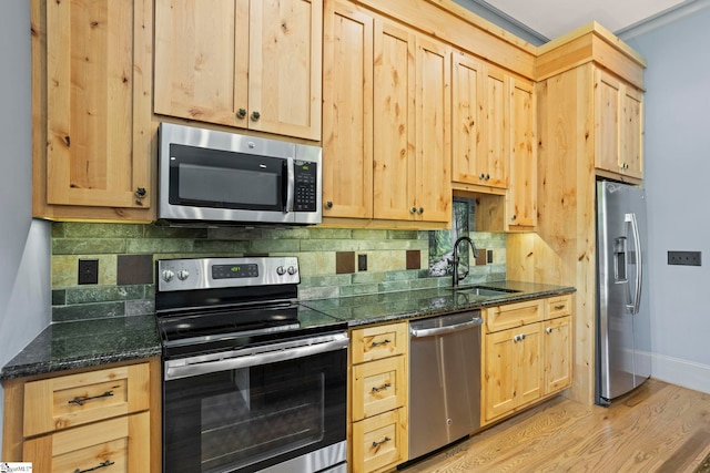 160 Mountain Brook Trl, Greenville, SC 29609 - kitchen with appliances with stainless steel finishes, light brown cabinetry, a sink, and decorative backsplash
