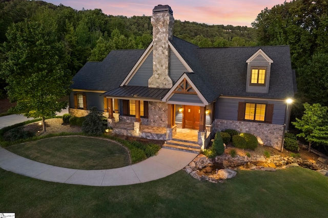160 Mountain Brook Trl, Greenville, SC 29609 - view of front facade with stone siding, a porch, a yard, a standing seam roof, and a chimney