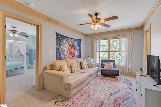living area with a ceiling fan, light colored carpet, ornamental molding, and baseboards