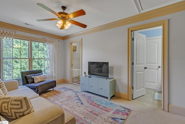 living area with a ceiling fan, baseboards, carpet floors, and ornamental molding