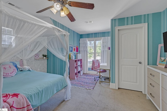carpeted bedroom featuring wallpapered walls and a ceiling fan