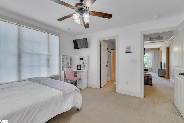 bedroom with light colored carpet, baseboards, a desk, and ceiling fan