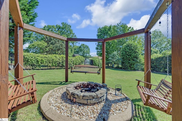 view of grassy yard with an outdoor fire pit
