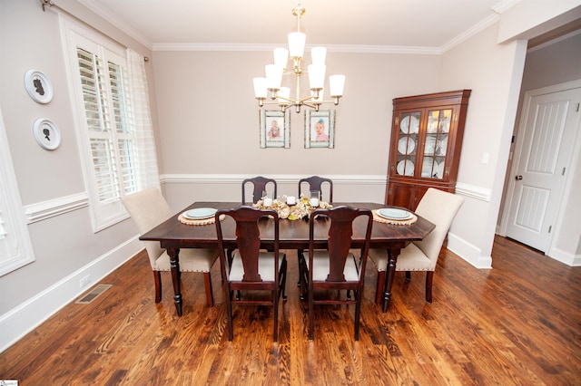 dining space featuring ornamental molding, a chandelier, wood finished floors, and baseboards