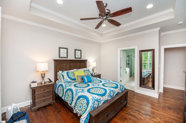 bedroom featuring a tray ceiling, dark wood finished floors, recessed lighting, and crown molding