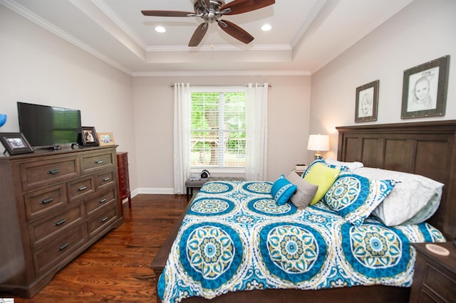 bedroom with a tray ceiling, dark wood-style flooring, ornamental molding, recessed lighting, and baseboards