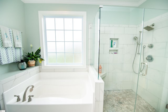 full bath with crown molding, a garden tub, and a stall shower