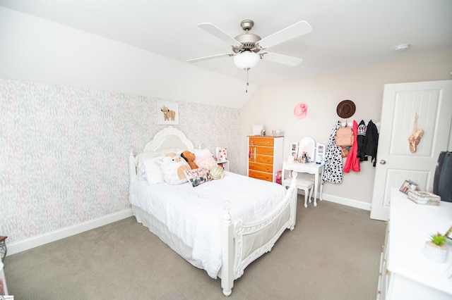 bedroom featuring light colored carpet, baseboards, wallpapered walls, a ceiling fan, and vaulted ceiling