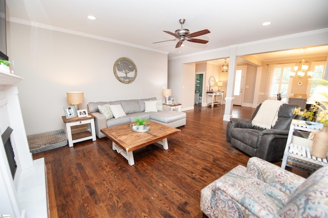living room featuring a fireplace, crown molding, ceiling fan, wood finished floors, and a chandelier