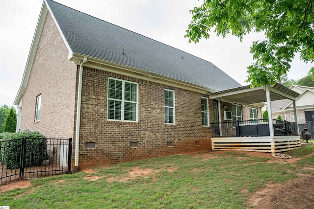 back of property featuring crawl space, roof with shingles, brick siding, and a deck